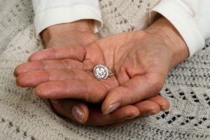 Holding Engagement Ring in Hand