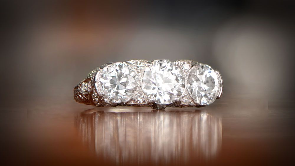 Three stone diamond engagement ring with platinum wood