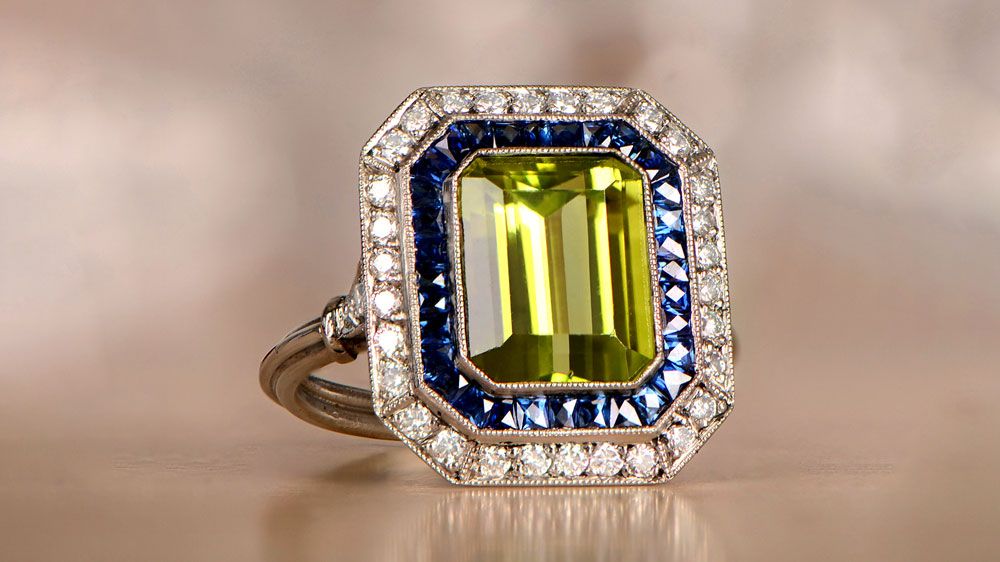 Cald Peridot Ring With Sapphire And Diamond Halos