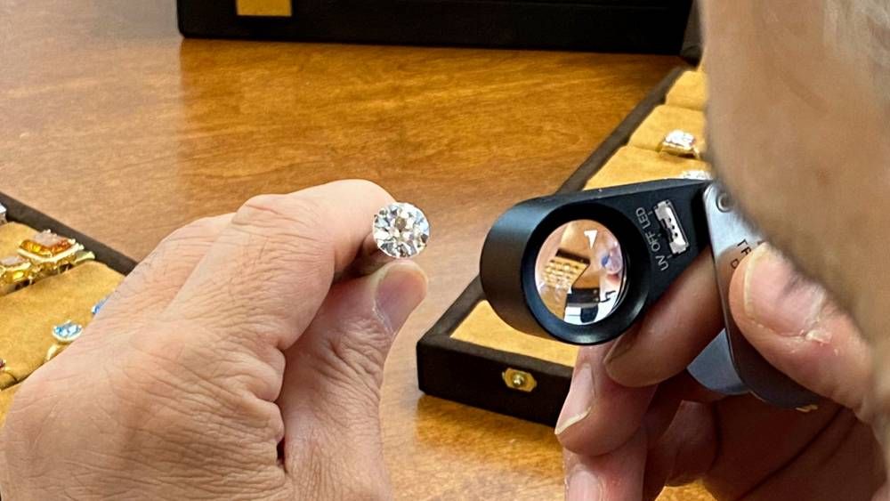 Examining a 3.5 carat diamond with loupe