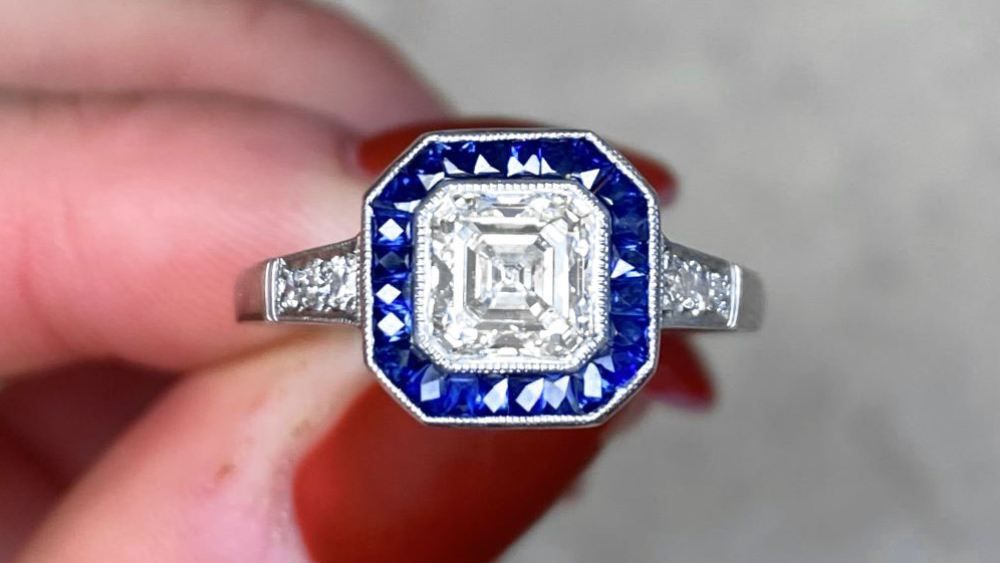 Montgomery Diamond Ring Featuring A Halo Of Sapphires