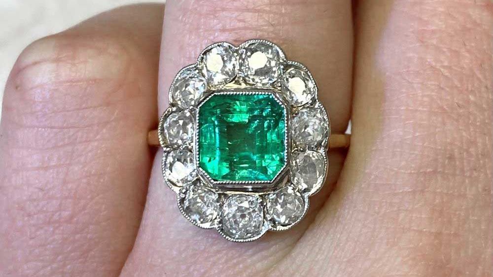 Edwardian Era Emerald Engagement Ring Featuring Floral Halo