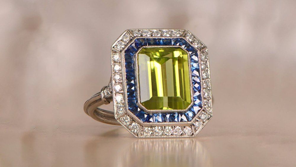 Cald Peridot Ring Featuring Diamond And Sapphire Halos