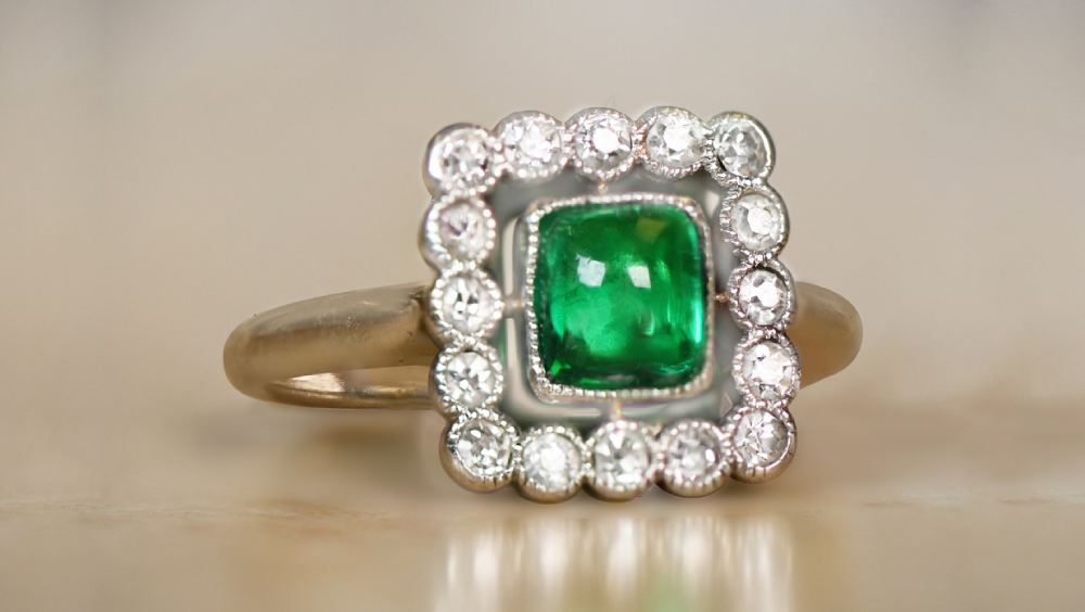 Emerald Centered Elmfield Engagement Ring Featuring Diamond Cluster