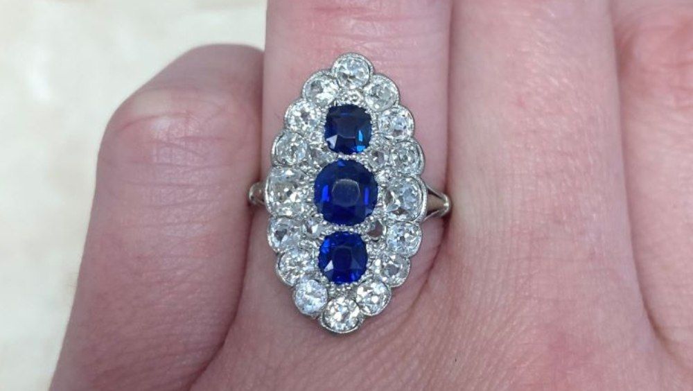 Elongated Three Stone Sapphire Ring With Floral Diamond Halo