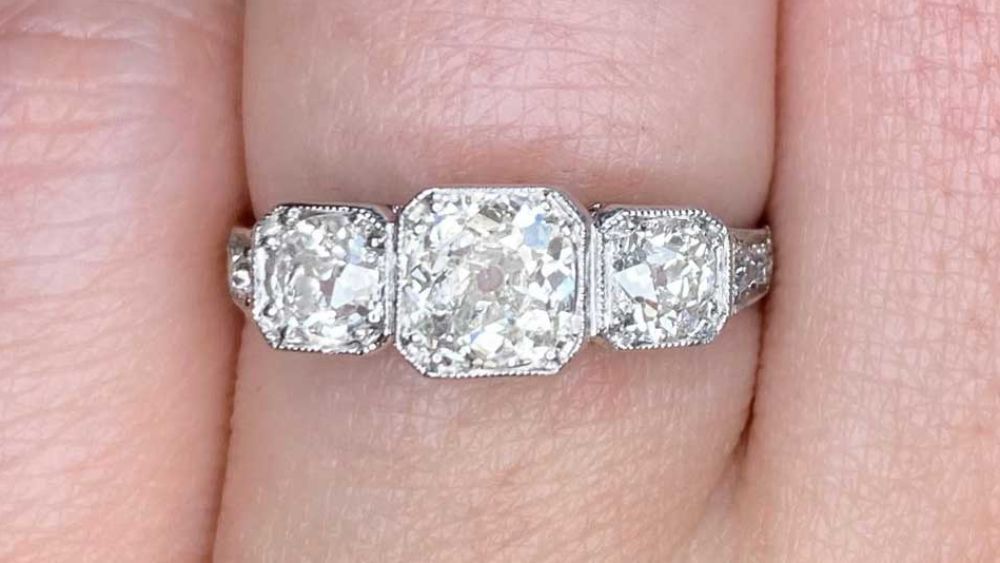 Three Stone Diamond Engagement Ring On Finger