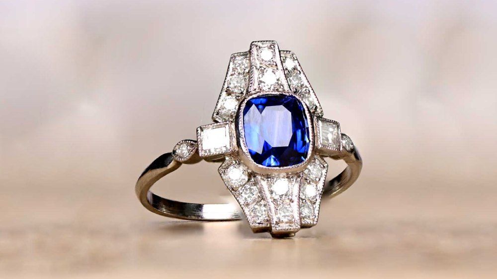 Uniquely Shaped Sapphire Ring With Surrounding Diamonds